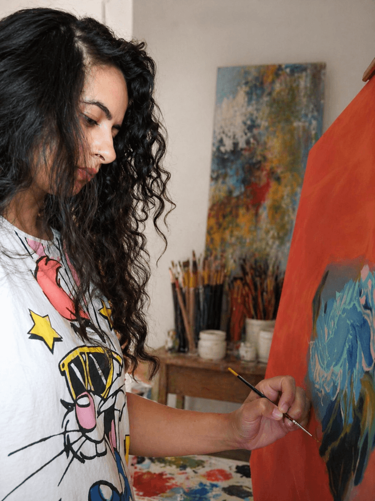 Artist painting on canvas while exploring color choices, reflecting the idea that there is no single right palette in art